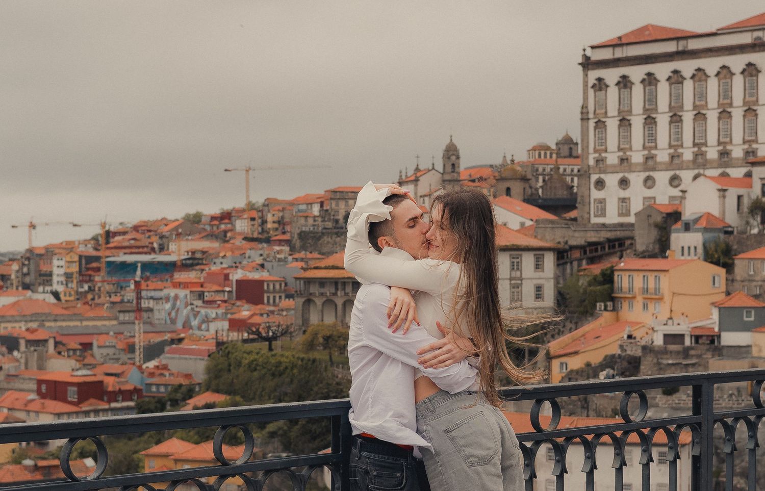 Panoramic romantic photoshoot overlooking historic Porto cityscape and architecture.