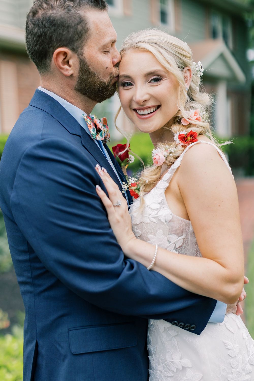A joyful wedding portrait showing a couple sharing a tender moment in formal attire outdoors in Orange County, New York.