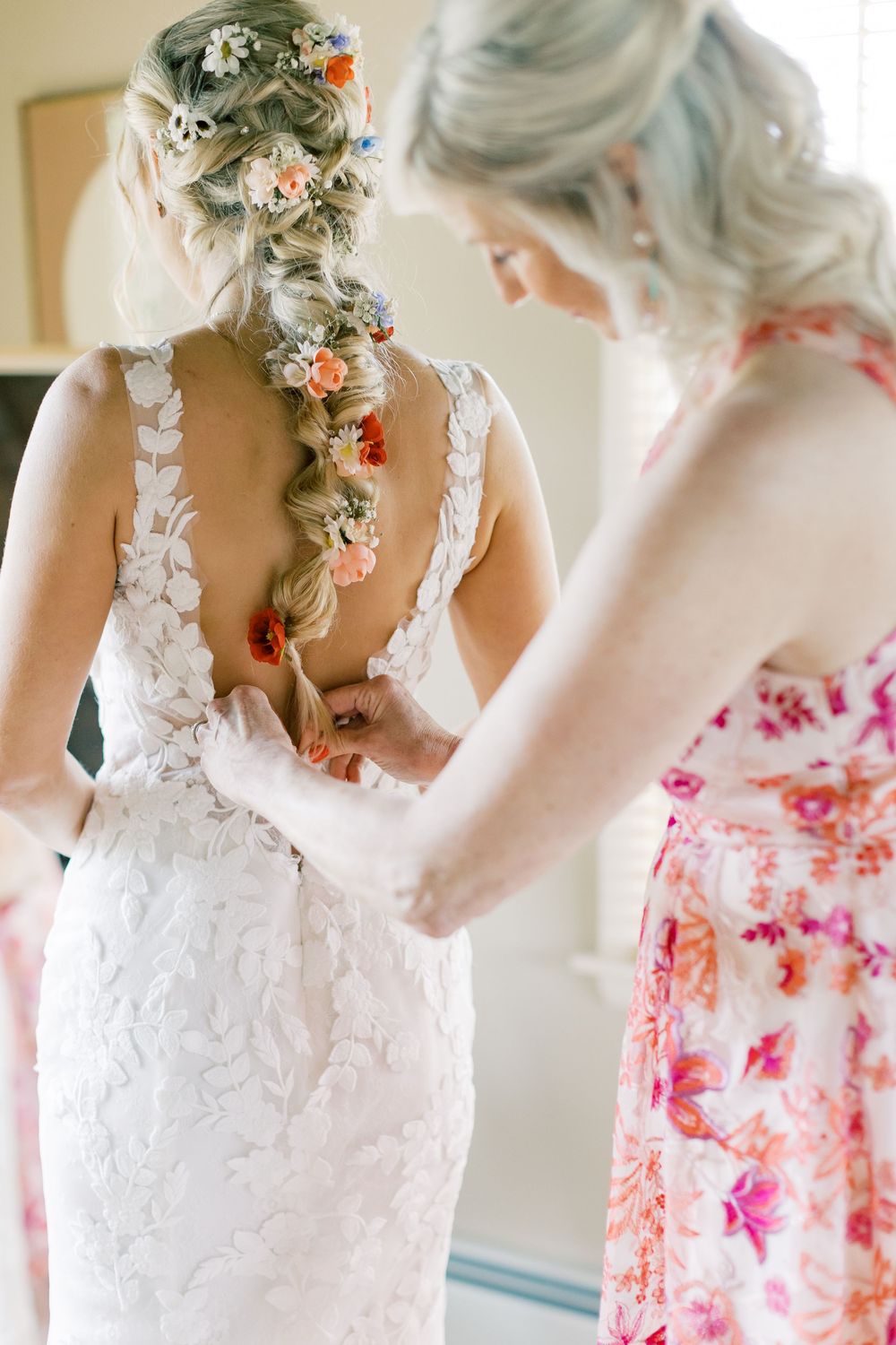 Intricate lace wedding dress with floral-adorned braid detail in Orange County, New York.