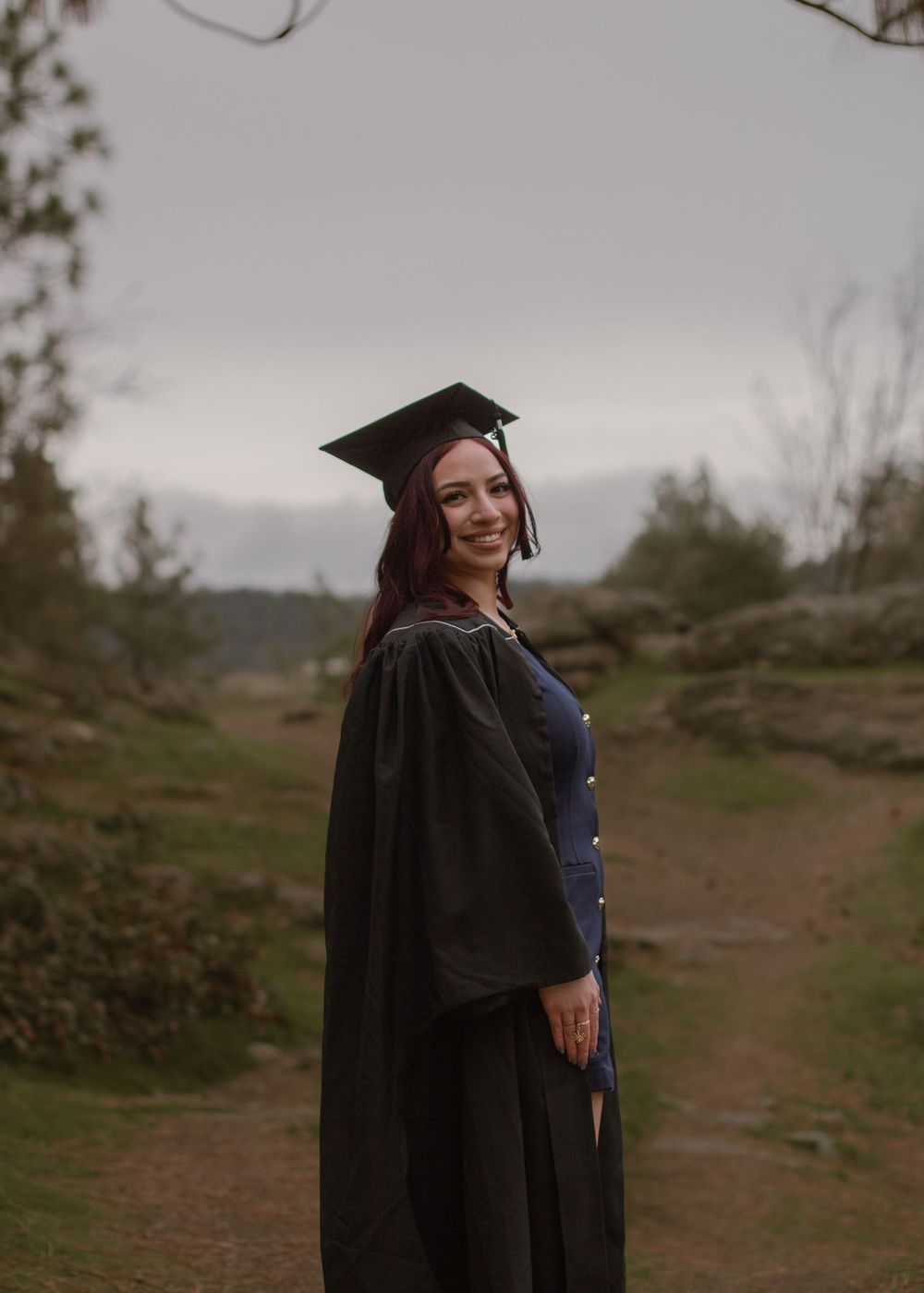 Masters degree in Psychology graduate in attire at Mirabeau Park.