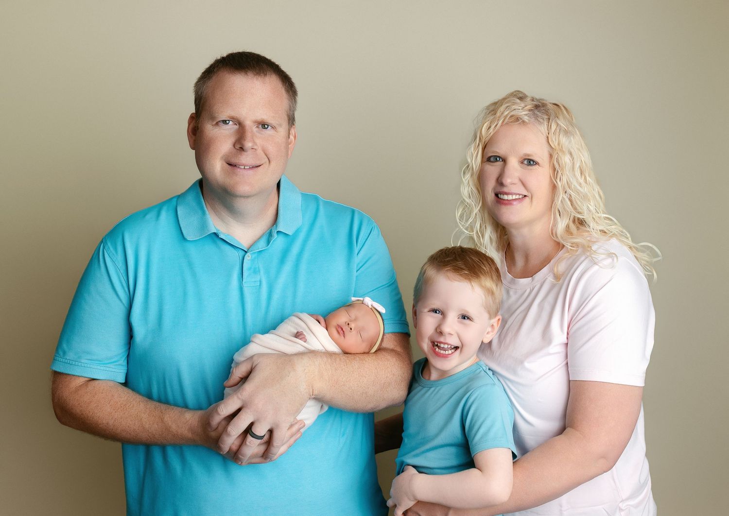 Family looking and all are smiling very big, holding the newborn. Greenville SC newborn photographer, Easley SC newborn photographer