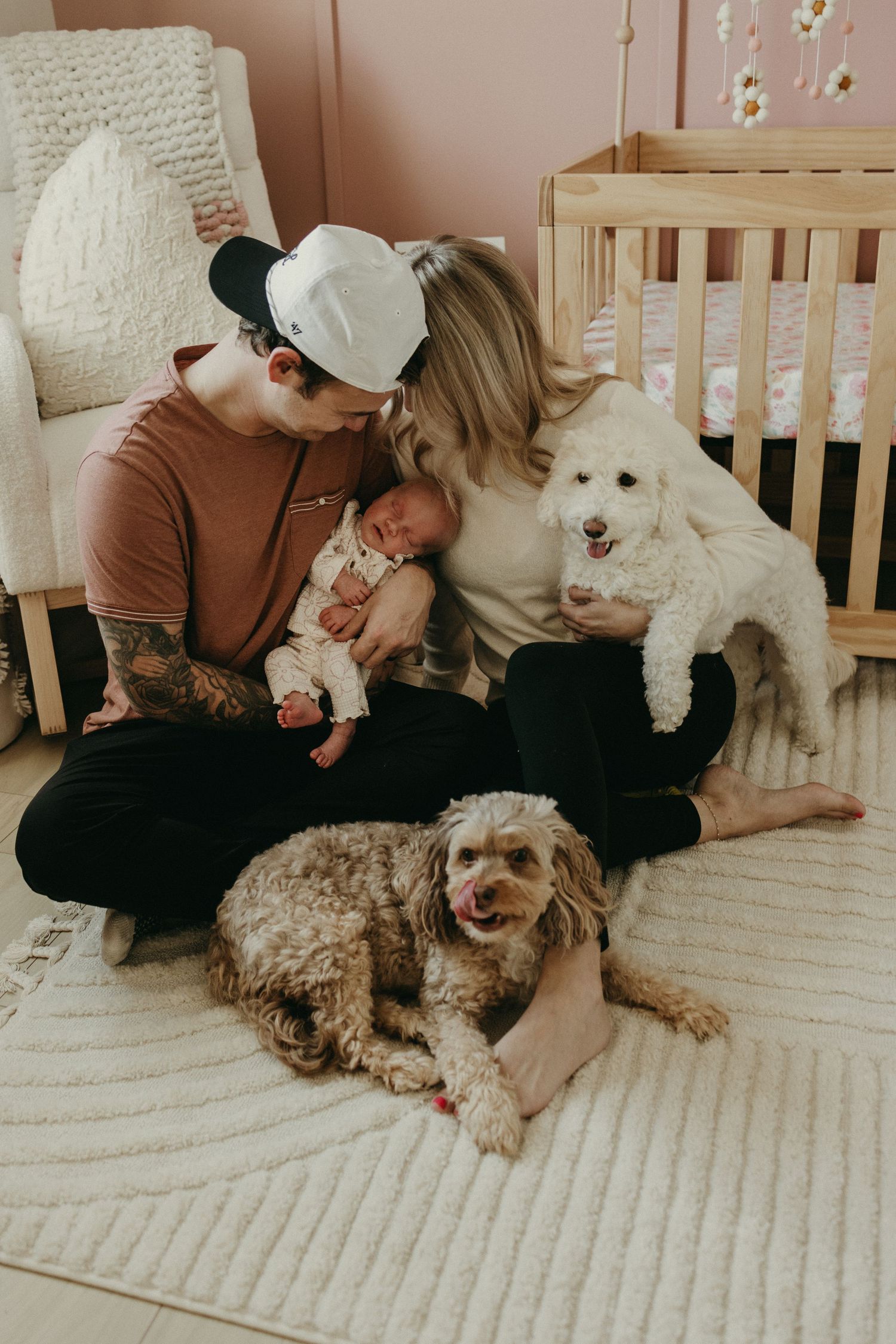 Candid lifestyle photos of family members cuddling with their fluffy dogs on a cozy bed.