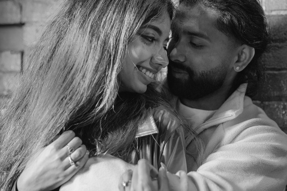 A romantic black and white photo series showing tender moments between a couple embracing and sharing intimate gestures.