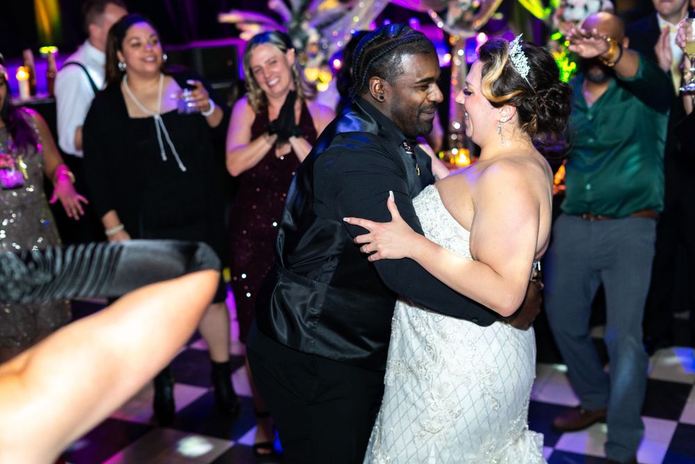 The groom pulls his bride close on the dance floor.
