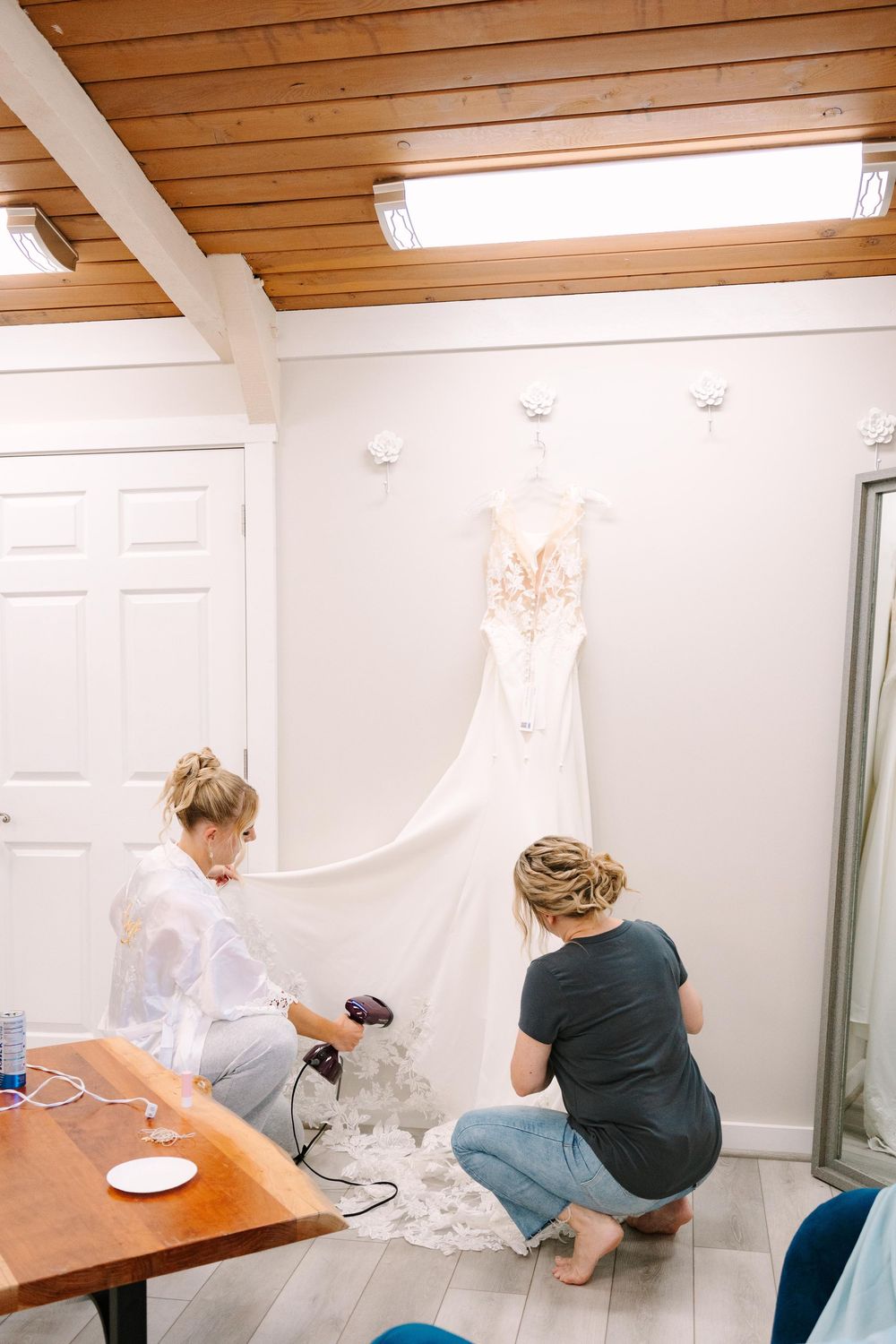Four sequential photos show someone cleaning a white bathroom with a wooden ceiling and white walls.