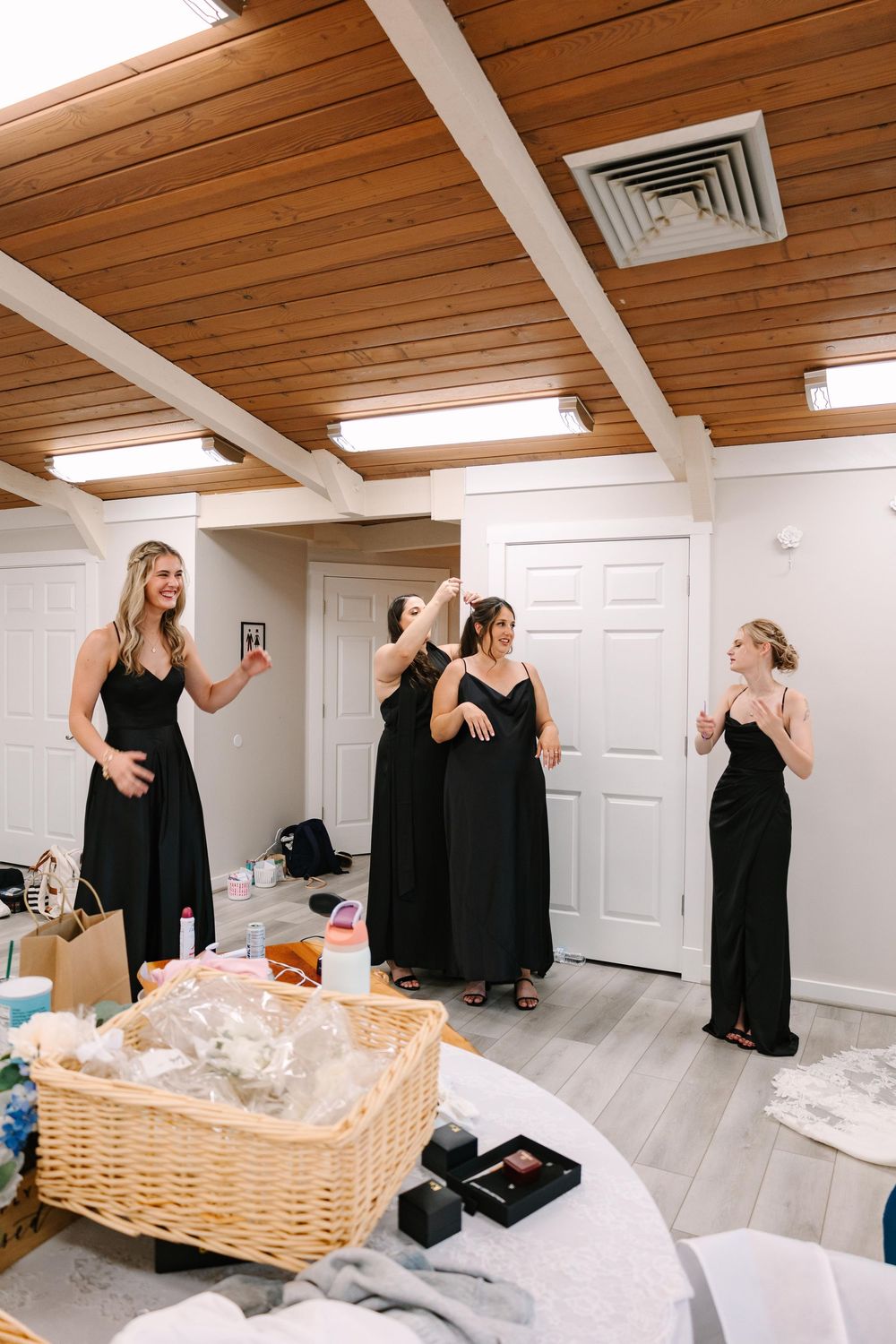 A sequence of photos showing someone in a black dress moving around a room with a wicker basket and various items.
