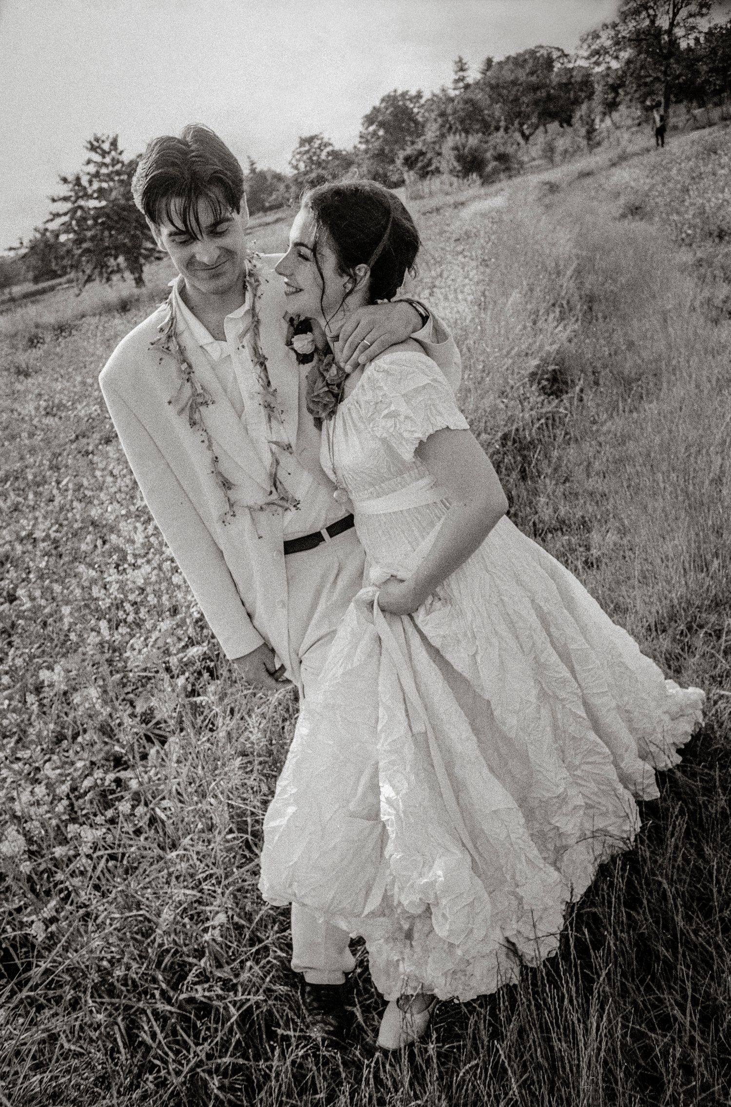 A tender outdoor moment captured in warm sunlight with soft golden tones.