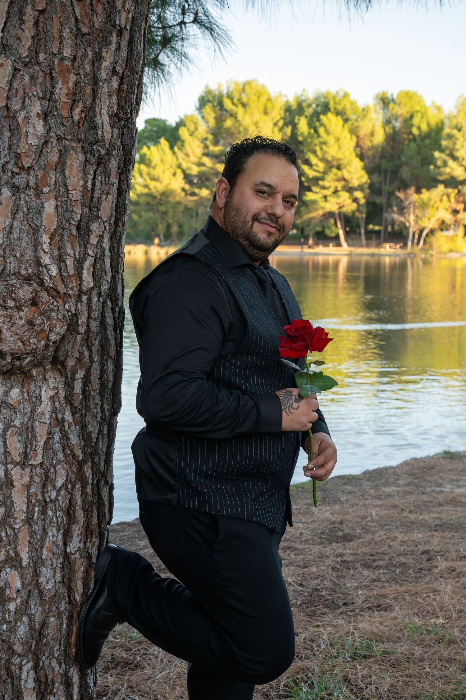 A series of outdoor portraits showing someone in black holding a red rose against a lakeside backdrop.