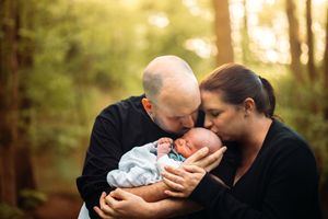 Intimate outdoor family portrait session in golden autumn sunlight.