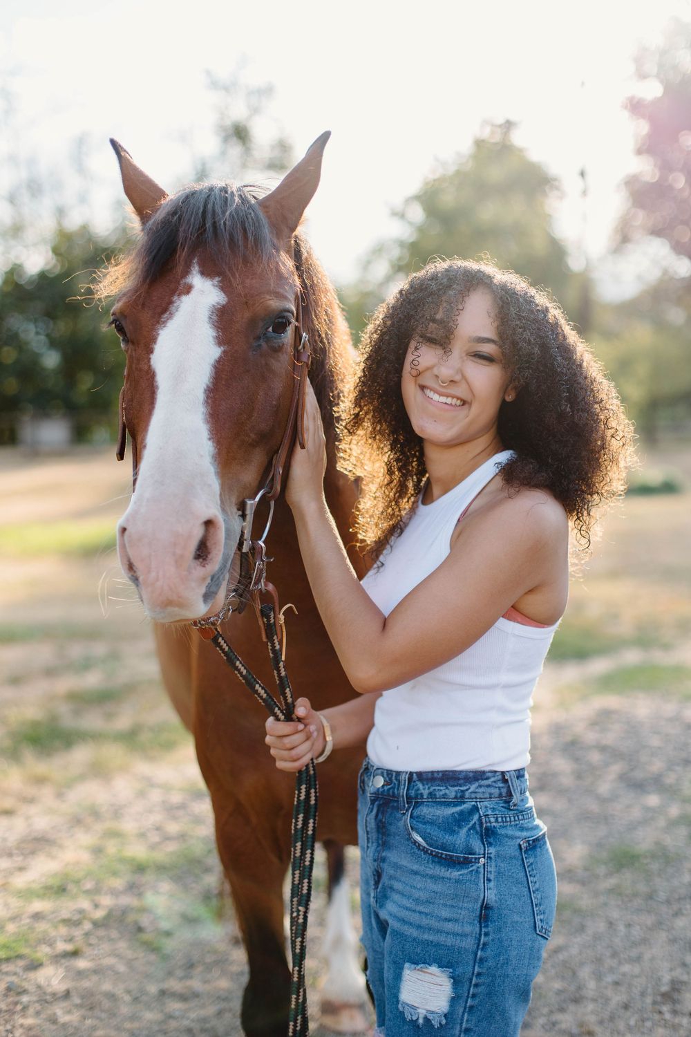 Sunset photoshoot featuring natural interactions with a brown and white horse.