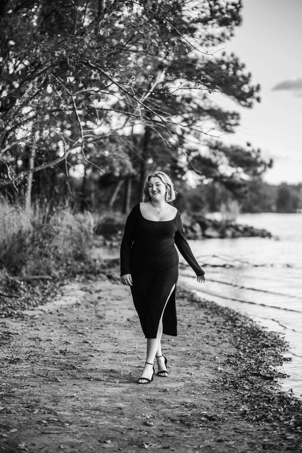 Black and white photo series along a scenic waterfront path with trees in the background.
