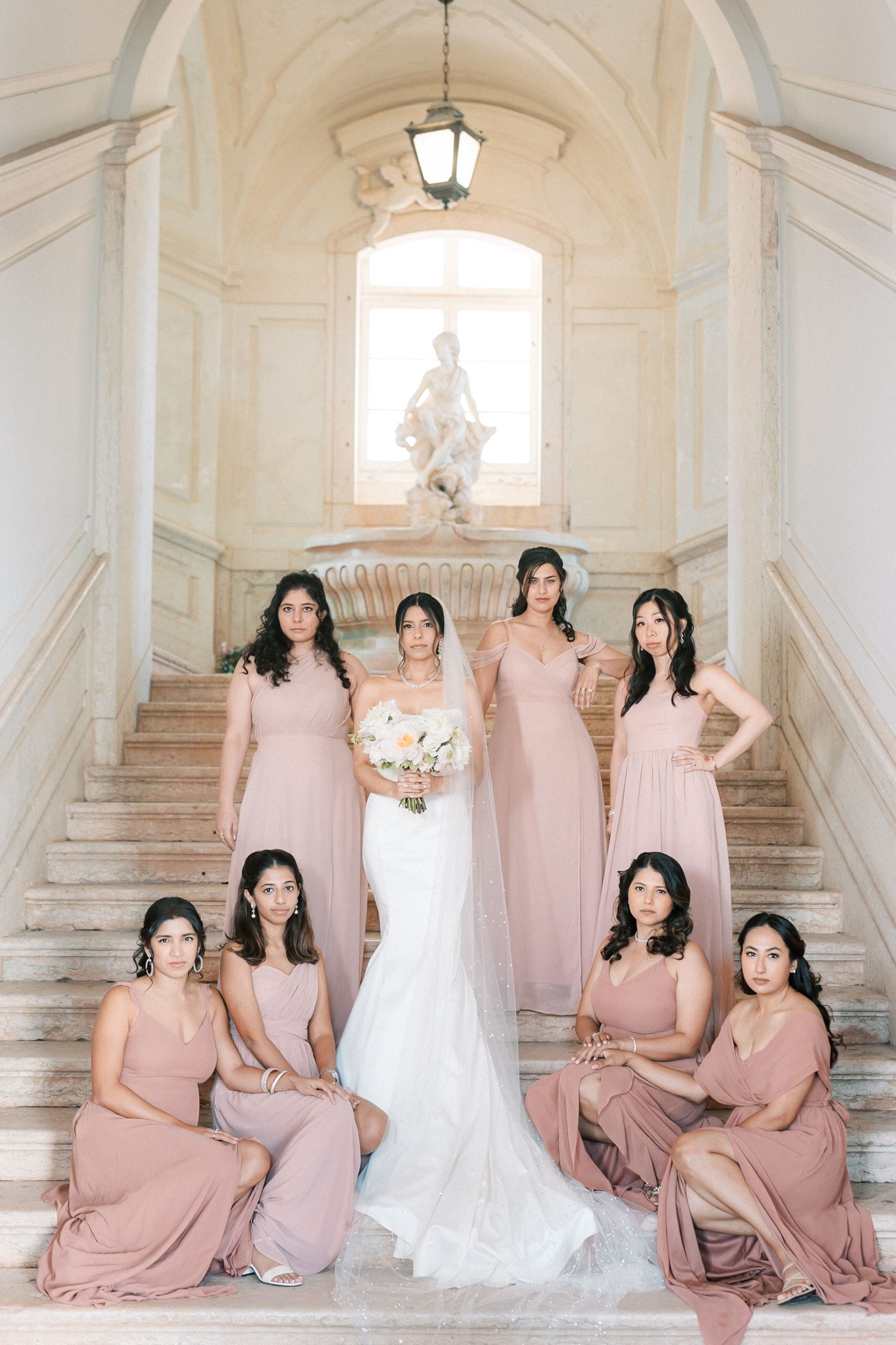 Bride with bridesmaids in blush dresses during luxury Indian wedding reception at Palácio do Correio-Mor, Portugal