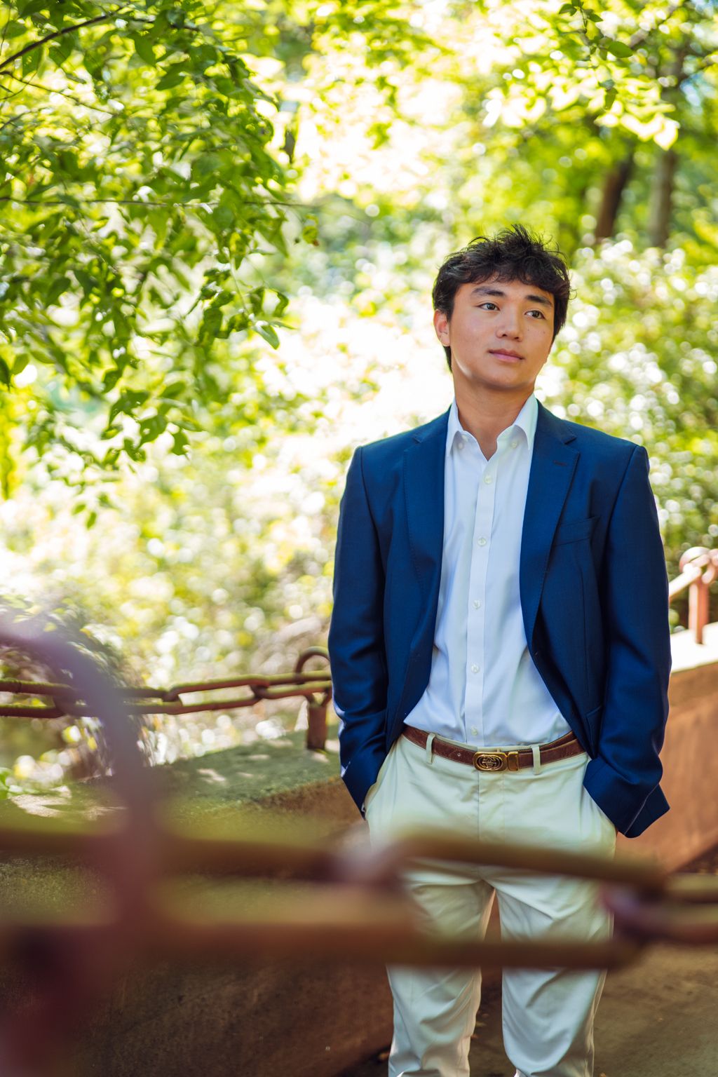Professional graduation photos taken in a lush garden setting with natural sunlight. High School Portraits by Eric Aaberg Photography in DF