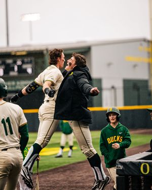 Baseball teammates celebrate on the field after a successful play.