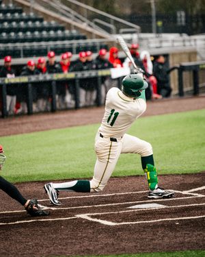 Close up of baseball cleats and batting stance at home plate during a game.