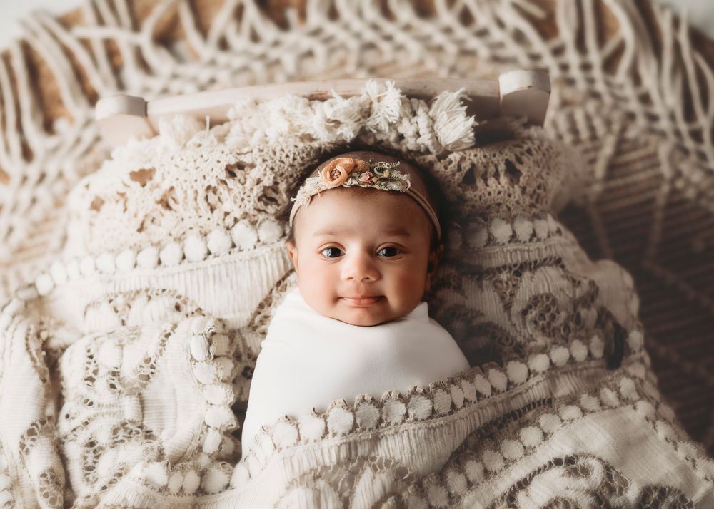Baby lying on textured cream knit blanket in progressive series of shots.