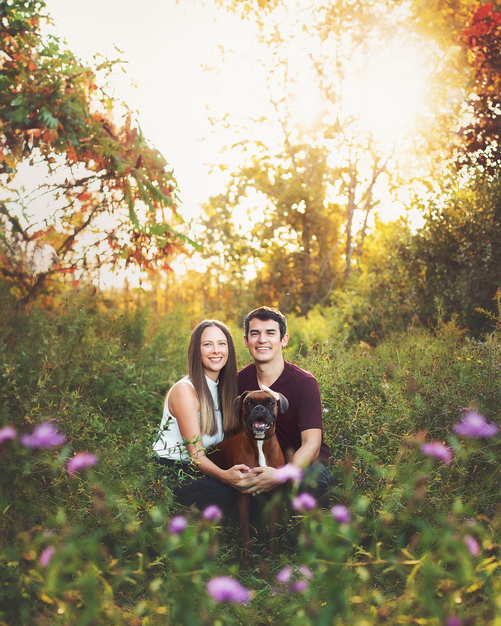 Romantic couple portrait in wildflower field during golden hour sunset.