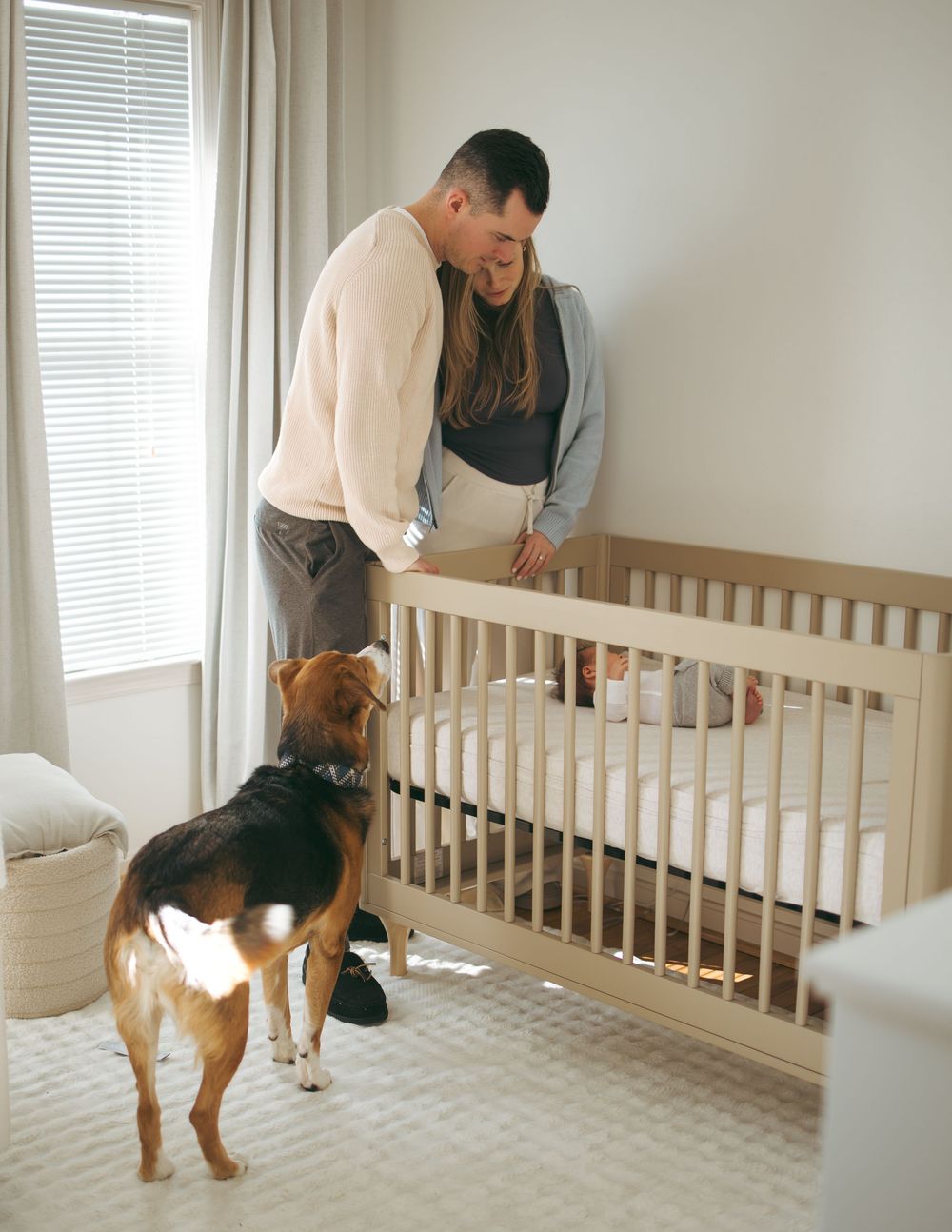 A series of photos showing someone assembling a wooden crib in a bright room with white walls and windows.