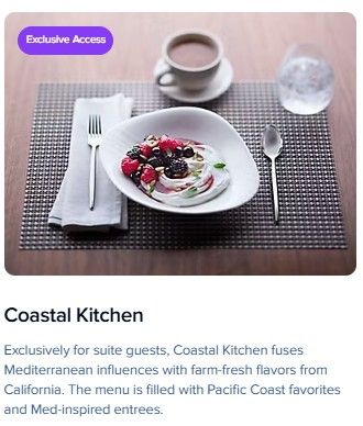 An elegant table setting with a white plate of berries and cream, accompanied by coffee and a placemat.