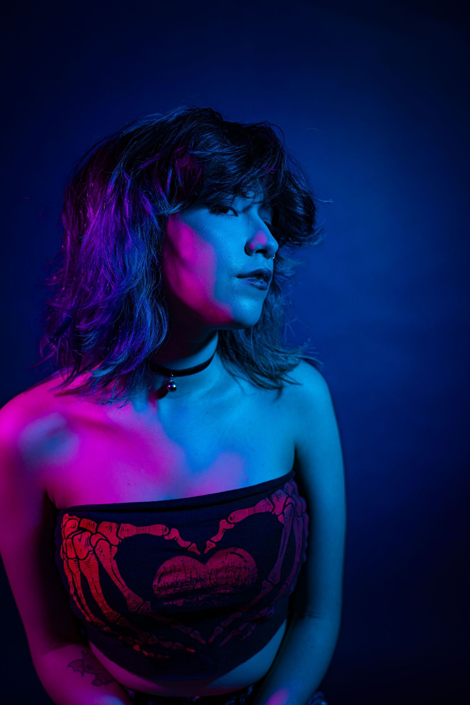 Artistic portrait series in neon pink and blue lighting showing dramatic poses against dark background.