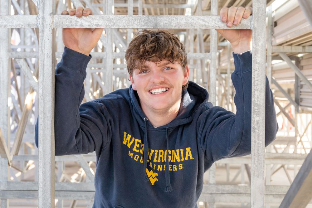 Senior boy posing in casual cloths with bright airy feeling in dynamic background.