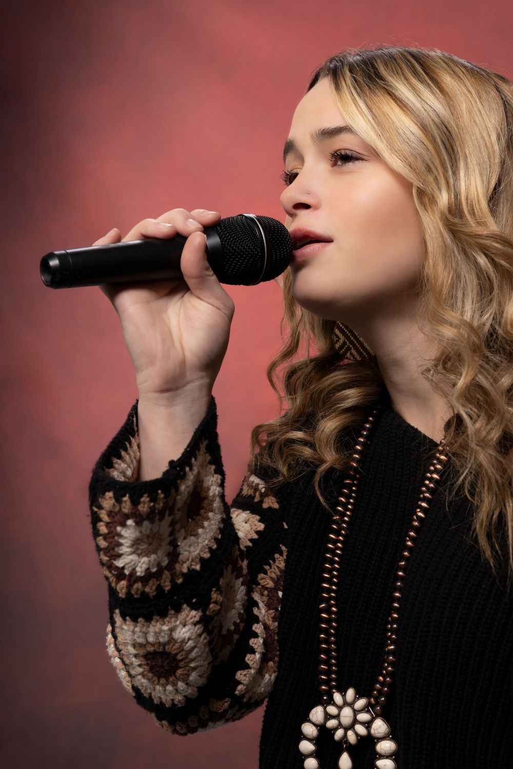 A musician poses in studio, captured with moody lighting and creative flair, reflecting passion, talent, and artistic identity.