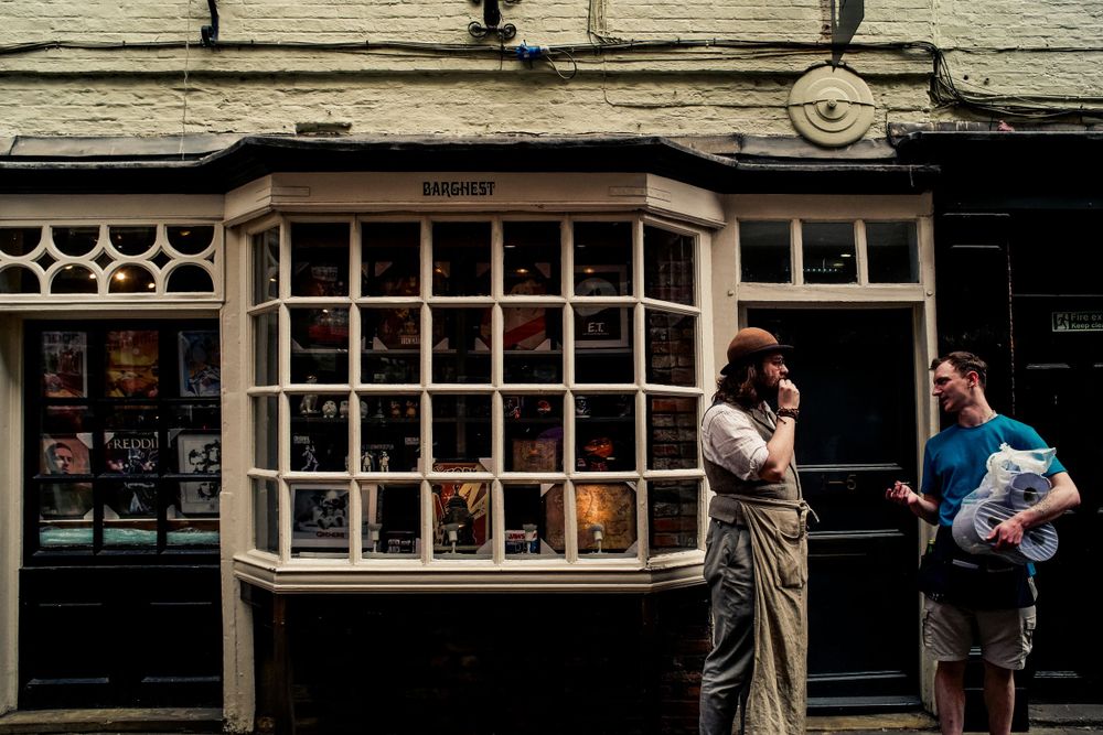 Historic shop window display with bow window in old English building.