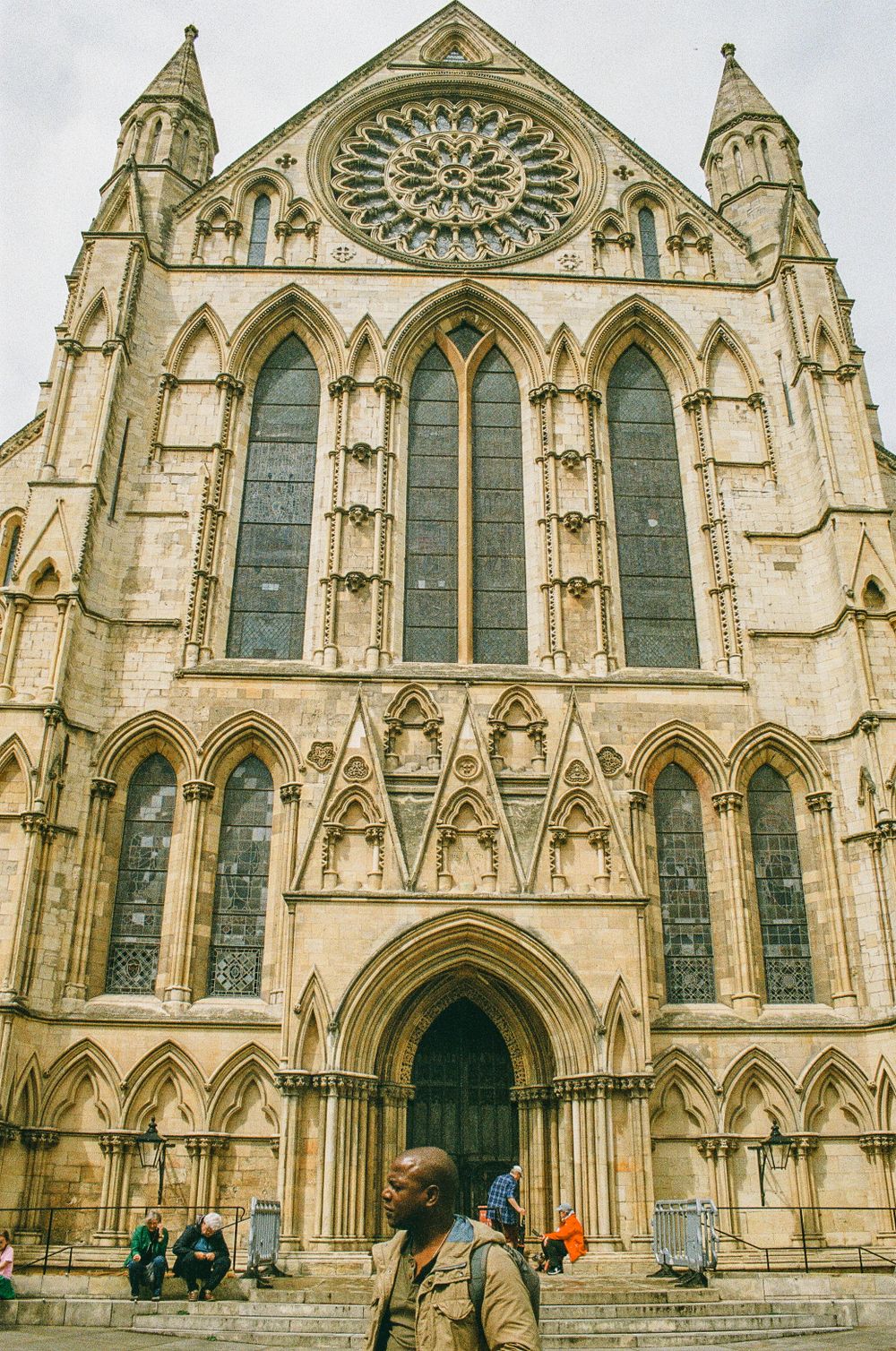 Gothic cathedral facade with large rose window and pointed arches in York.