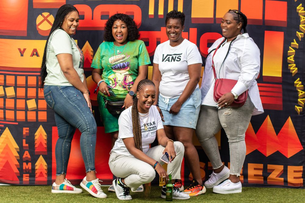 Group photo showing casual streetwear fashion against bright geometric backdrop.