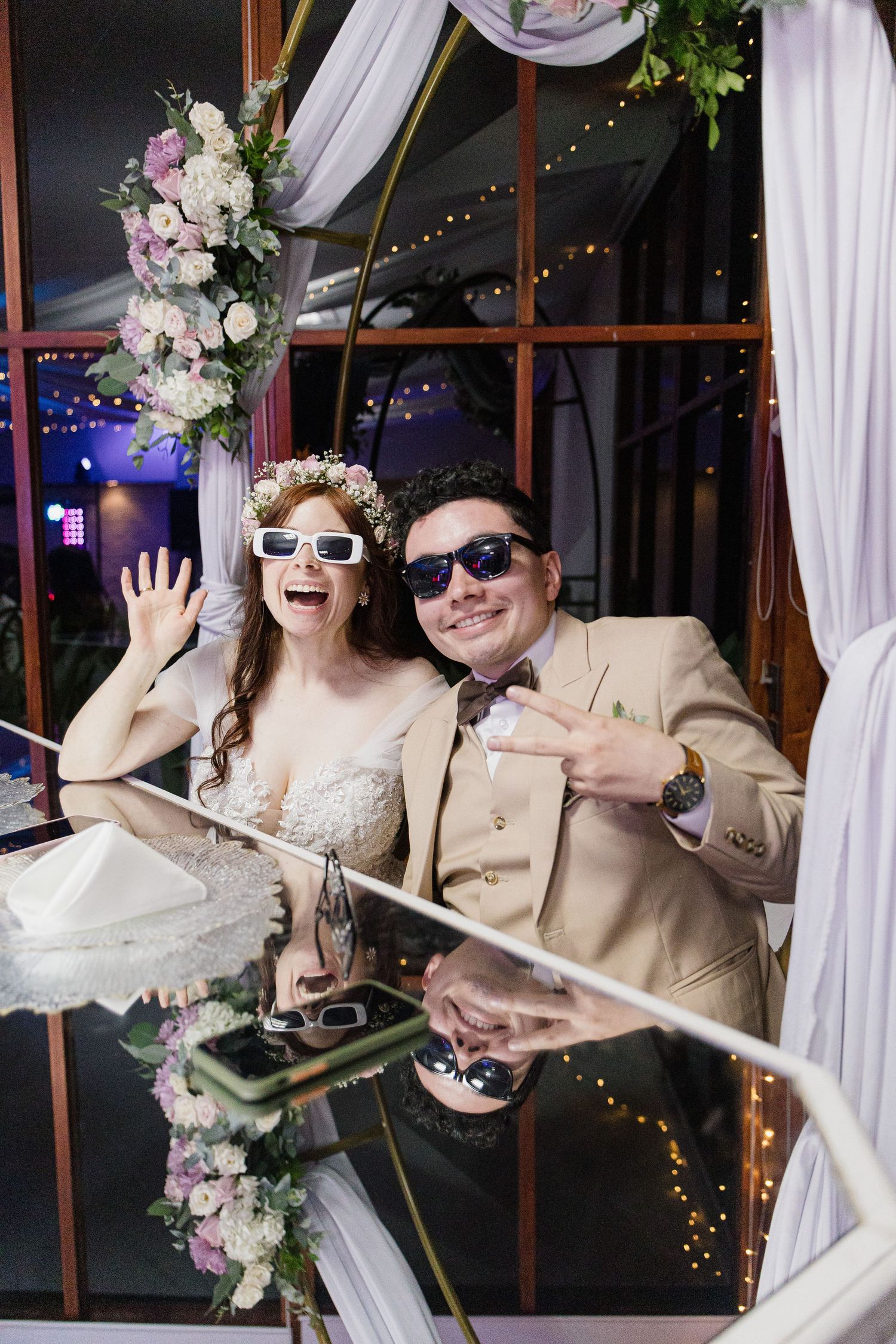 Wedding couple wearing sunglasses and having fun during their reception celebration.