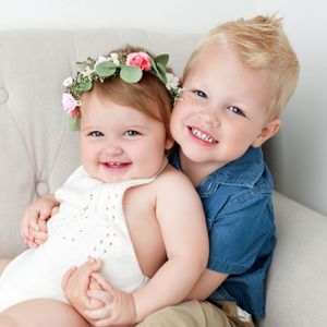 Child photographer in Menifee photo of smiling baby girl with big brother.