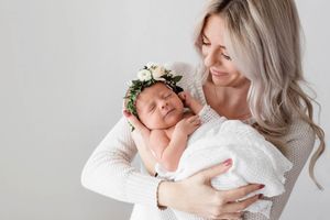 Mom holding newborn baby girl.