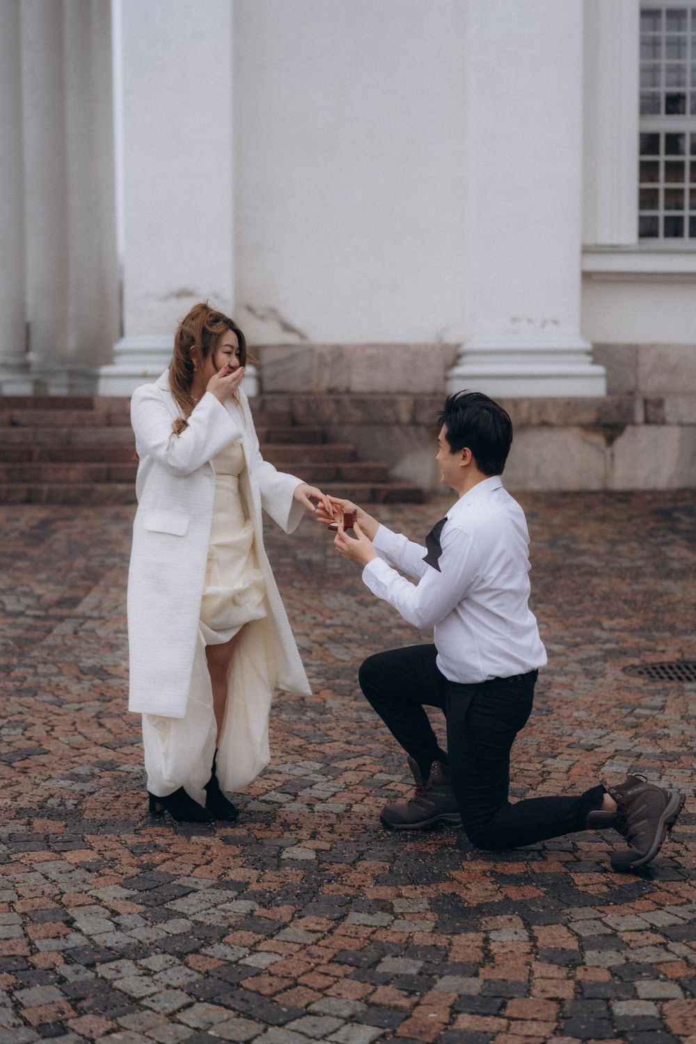 Surprise proposal at Helsinki Cathedral during an engagement session in Helsinki