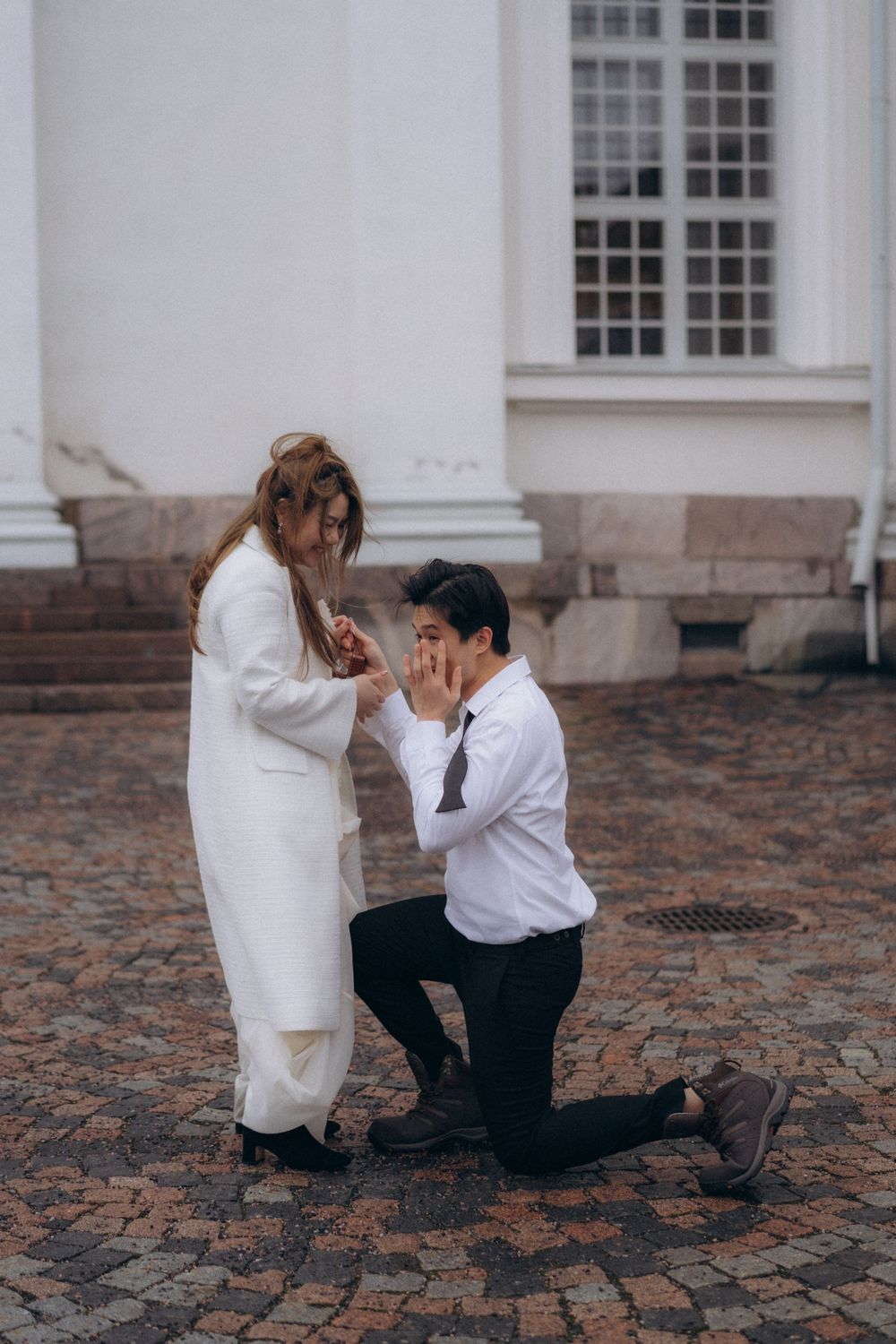 Surprise proposal at Helsinki Cathedral during an engagement session in Helsinki