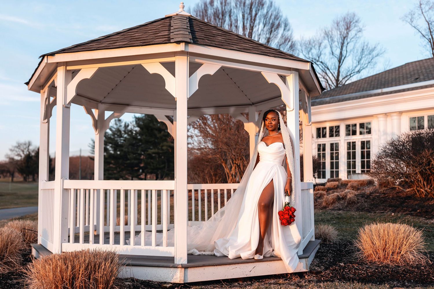 Elegant Black couple in wedding attire, bride in white gown with veil, groom in white tuxedo jacket, outdoors Deerfield Golf Club Newark DE