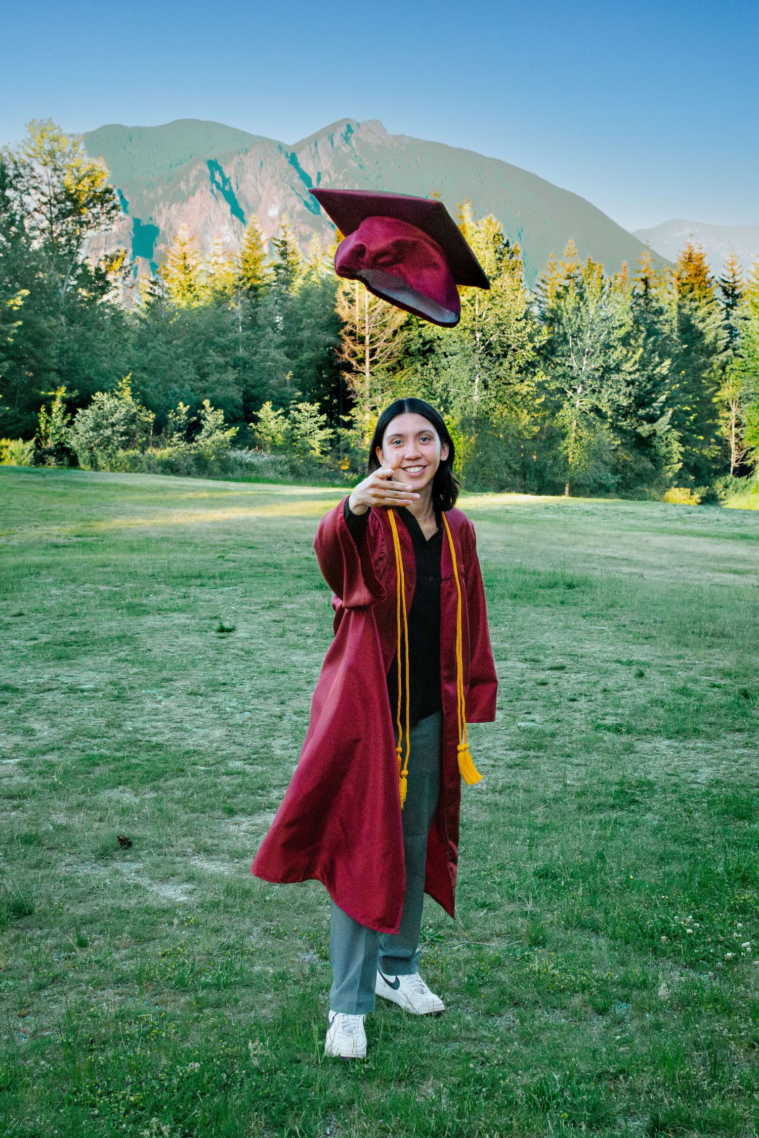 Graduating senior in cap and gown photo at Snoqualmie Point Park, near Seattle, Washington. Cap toss.