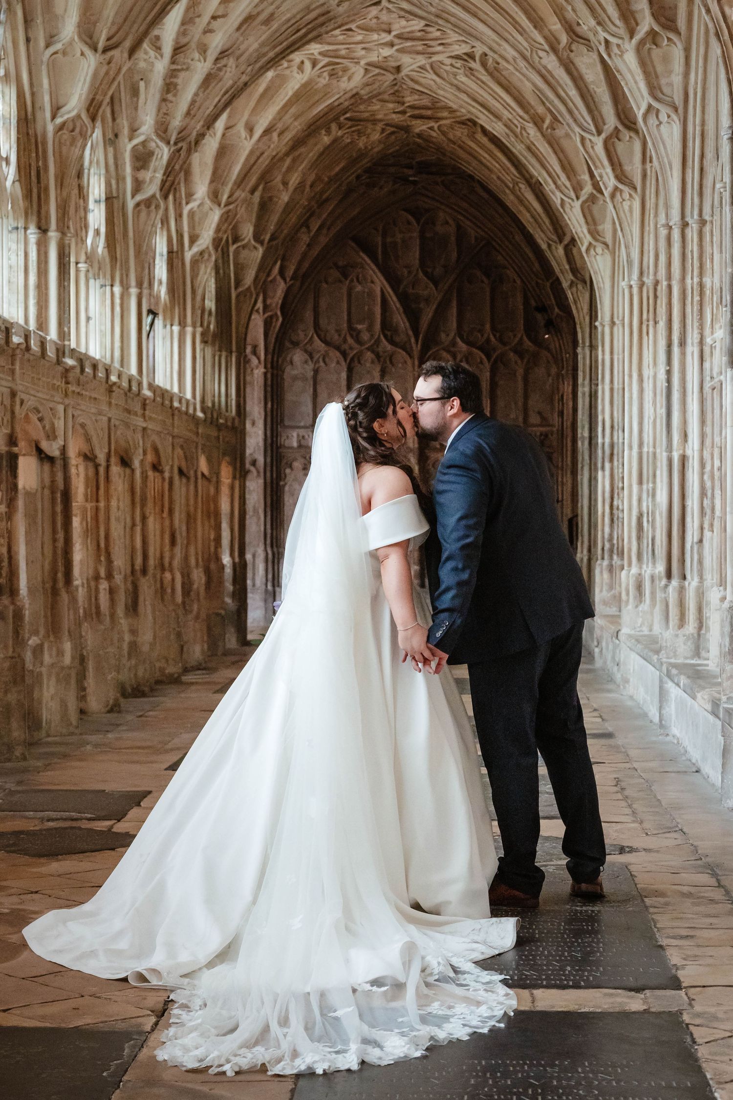 Gloucester Cathedral wedding photographer Gloucestershire Cheltenham Bride and Groom kissing in the cloister