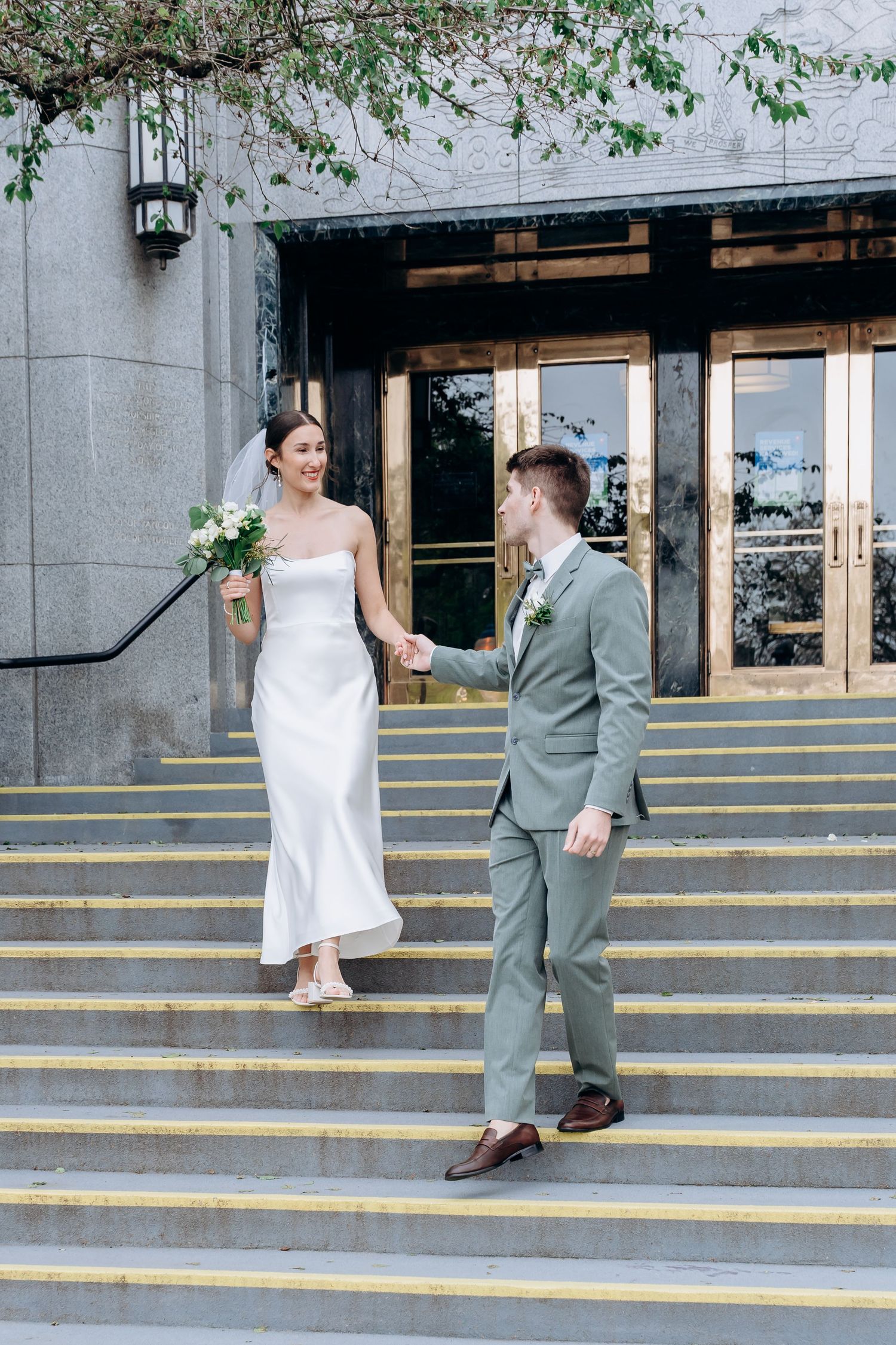 A sequence of wedding photos capturing a couple descending yellow-painted concrete steps in front of a stone building.