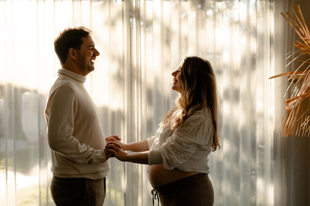 A romantic dance sequence captured in natural light with white curtains creating a soft ethereal backdrop.