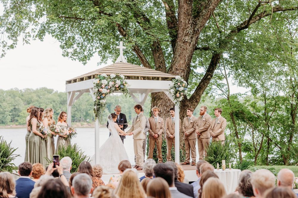 Bridal Party during the wedding ceremony under a beautiful gazebo by the river at The Inn at Oneonta in Northern Kentucky.