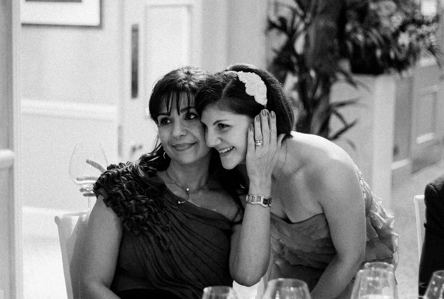 A black and white photo montage shows candid moments of laughter and joy at a social gathering.