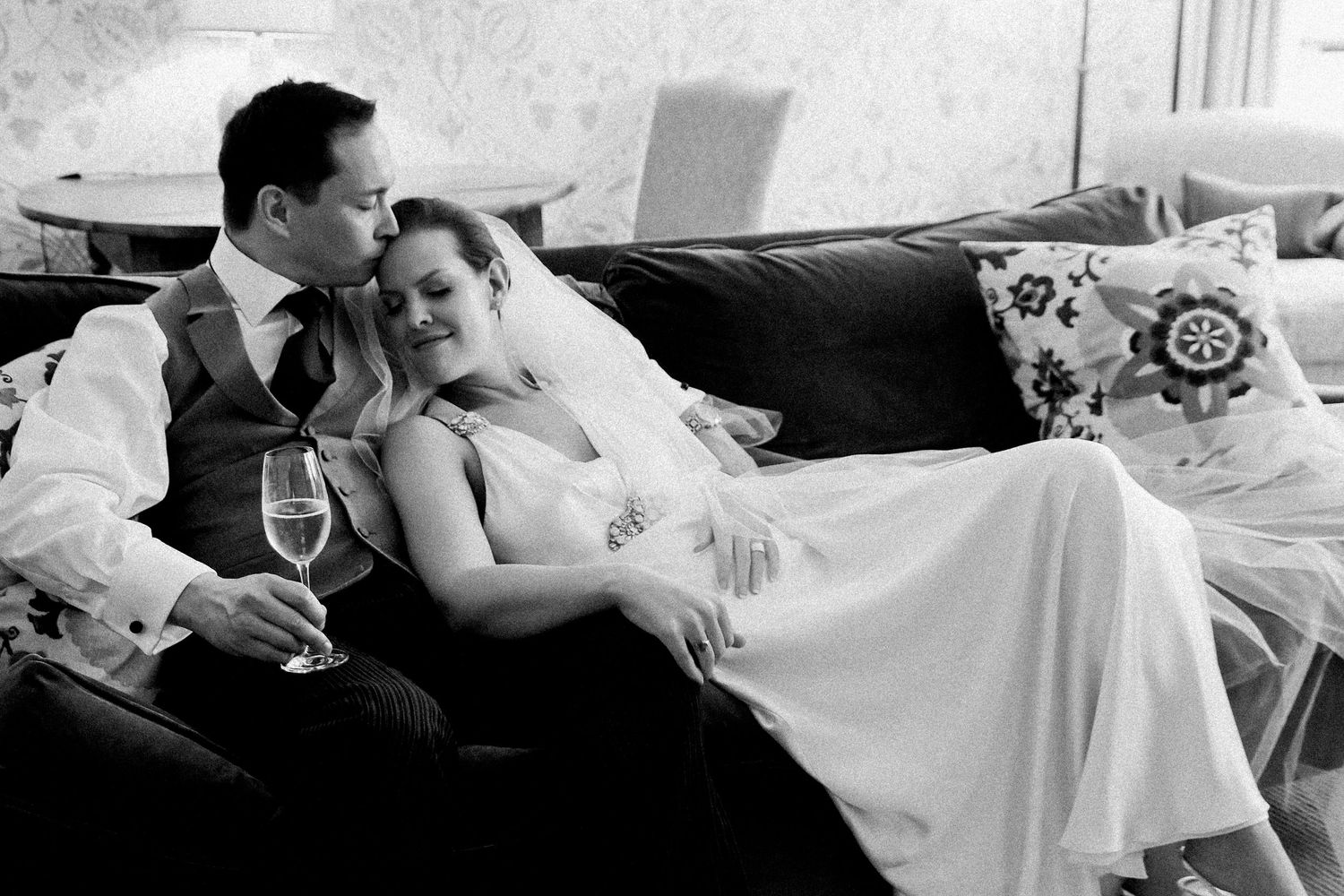 A romantic black and white photo collage showing tender moments between a bride and groom at their wedding celebration.
