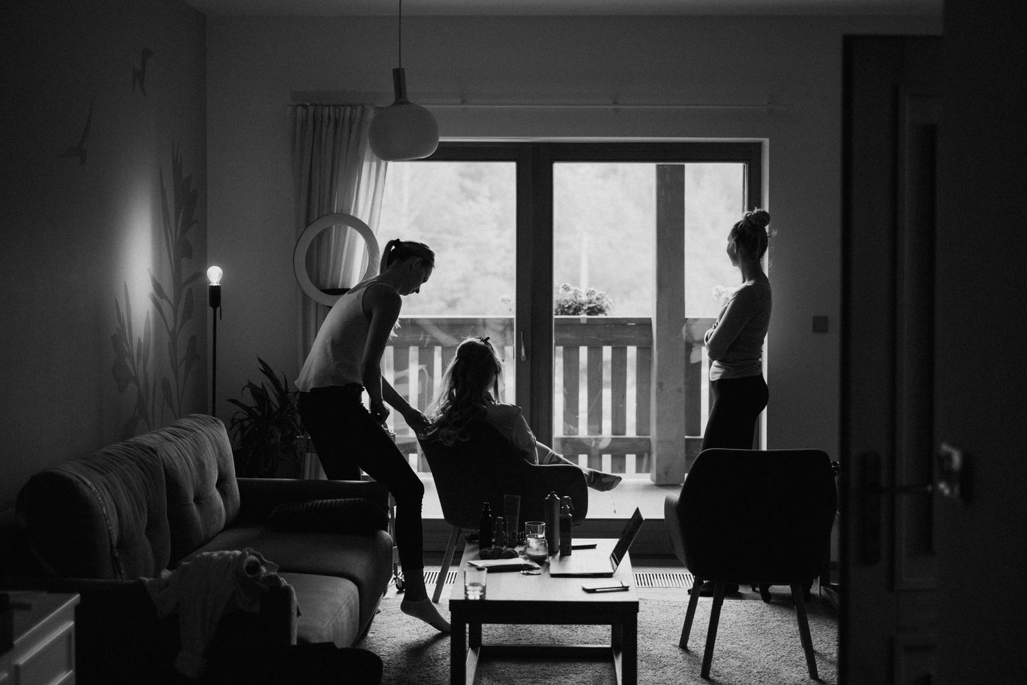 Dark silhouette of a room interior with window light creating dramatic shadows.
