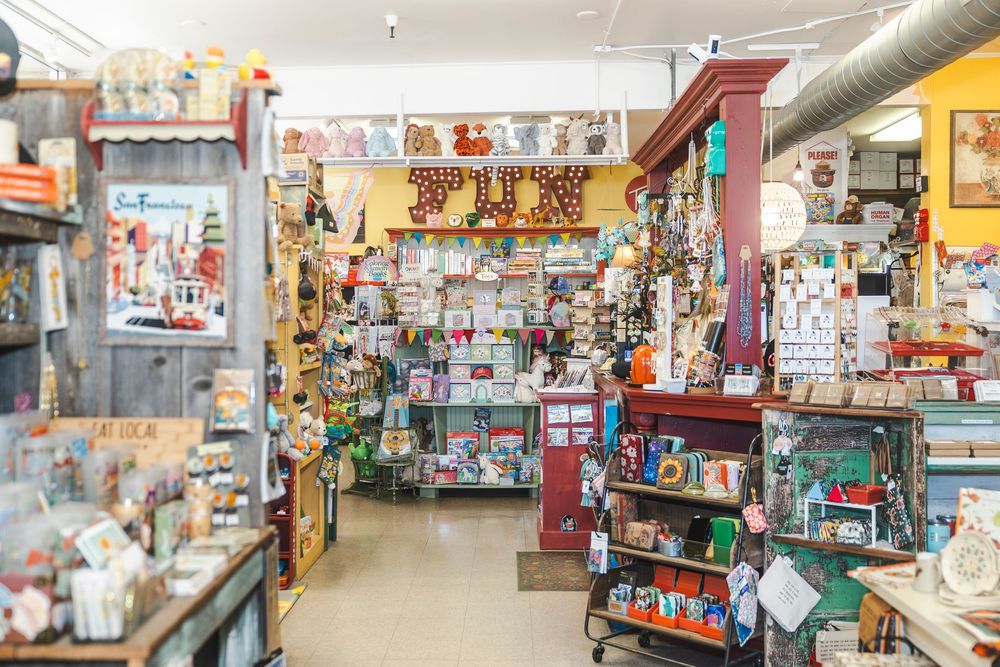 Interior view of a colorful retail store showing aisles filled with various merchandise and display shelves.