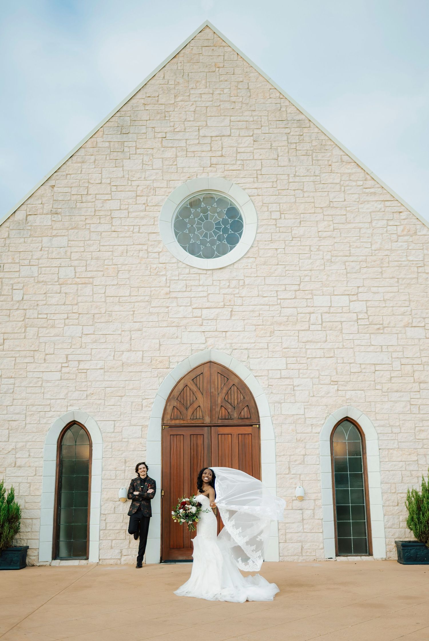 Chapel interior with wooden pews, exposed beams, and elegant crystal chandeliers.