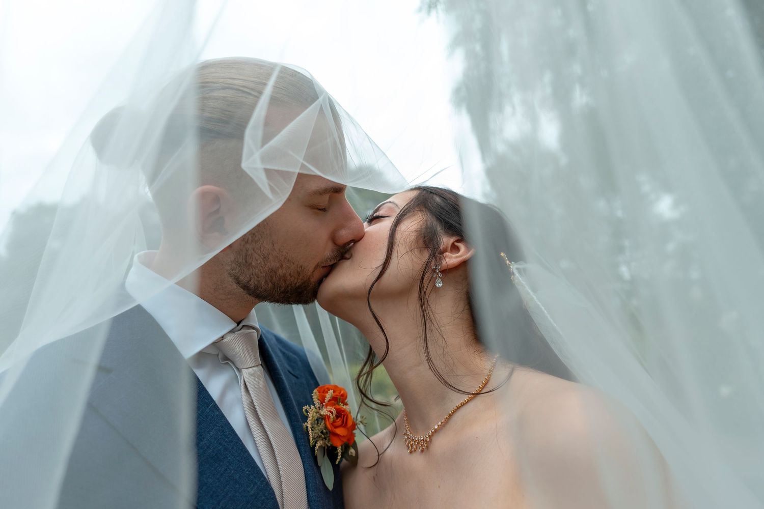 Emotionale Hochzeitsfotografie mit Brautpaar unter dem Schleier
