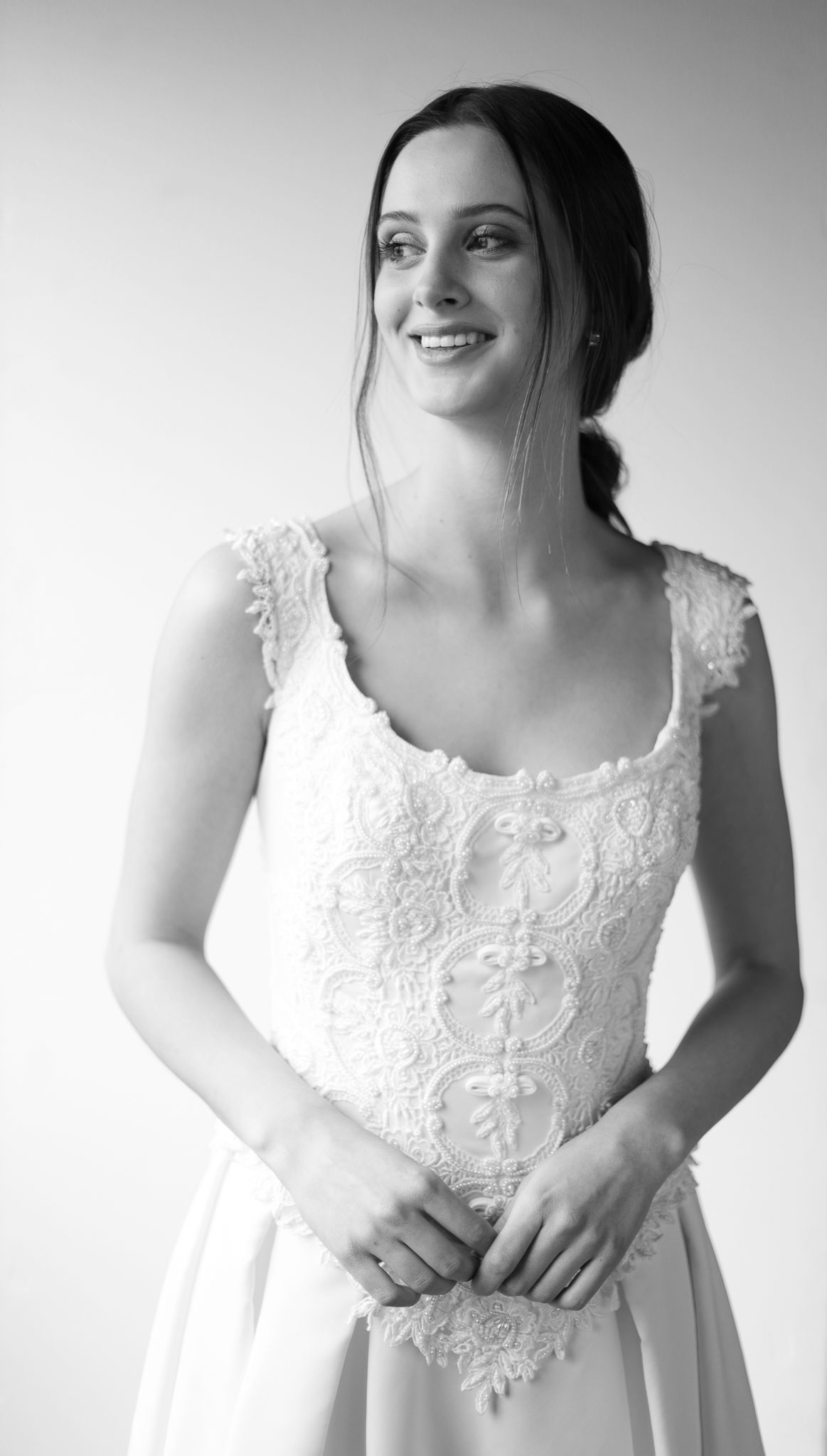 Black and white portrait series of person in white lace dress showing playful expressions.