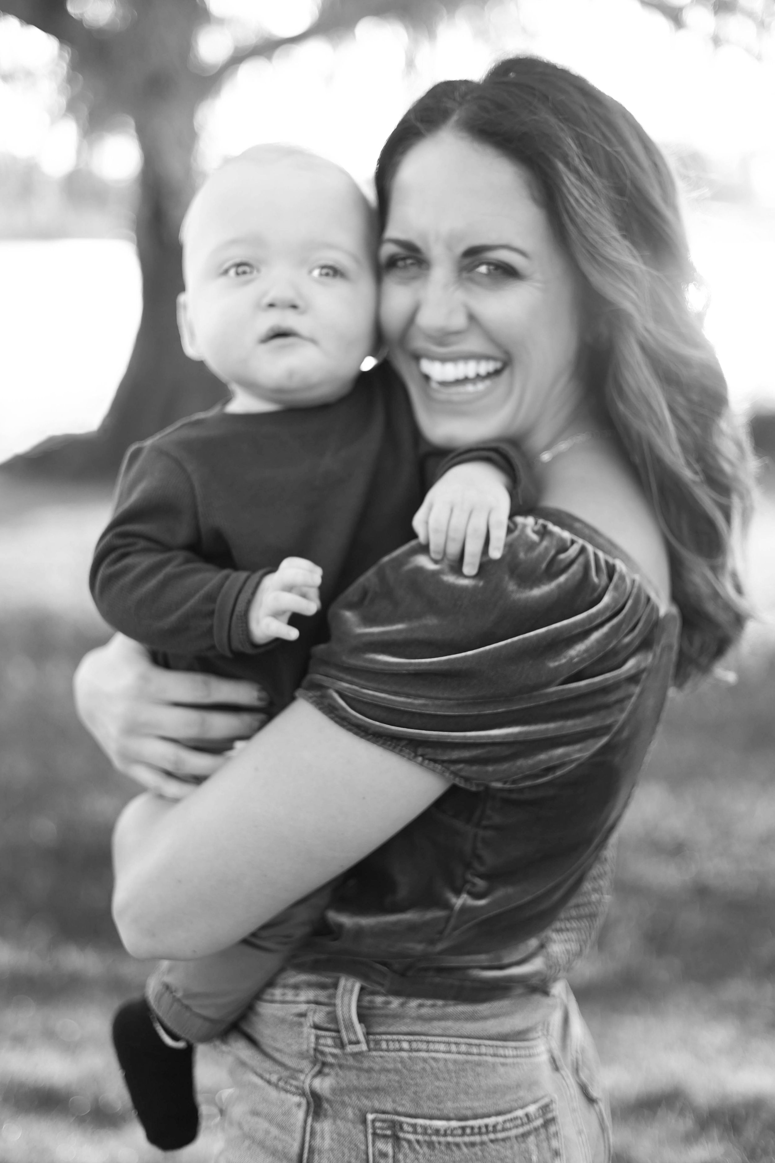 Black and white photo of mom and baby smiling