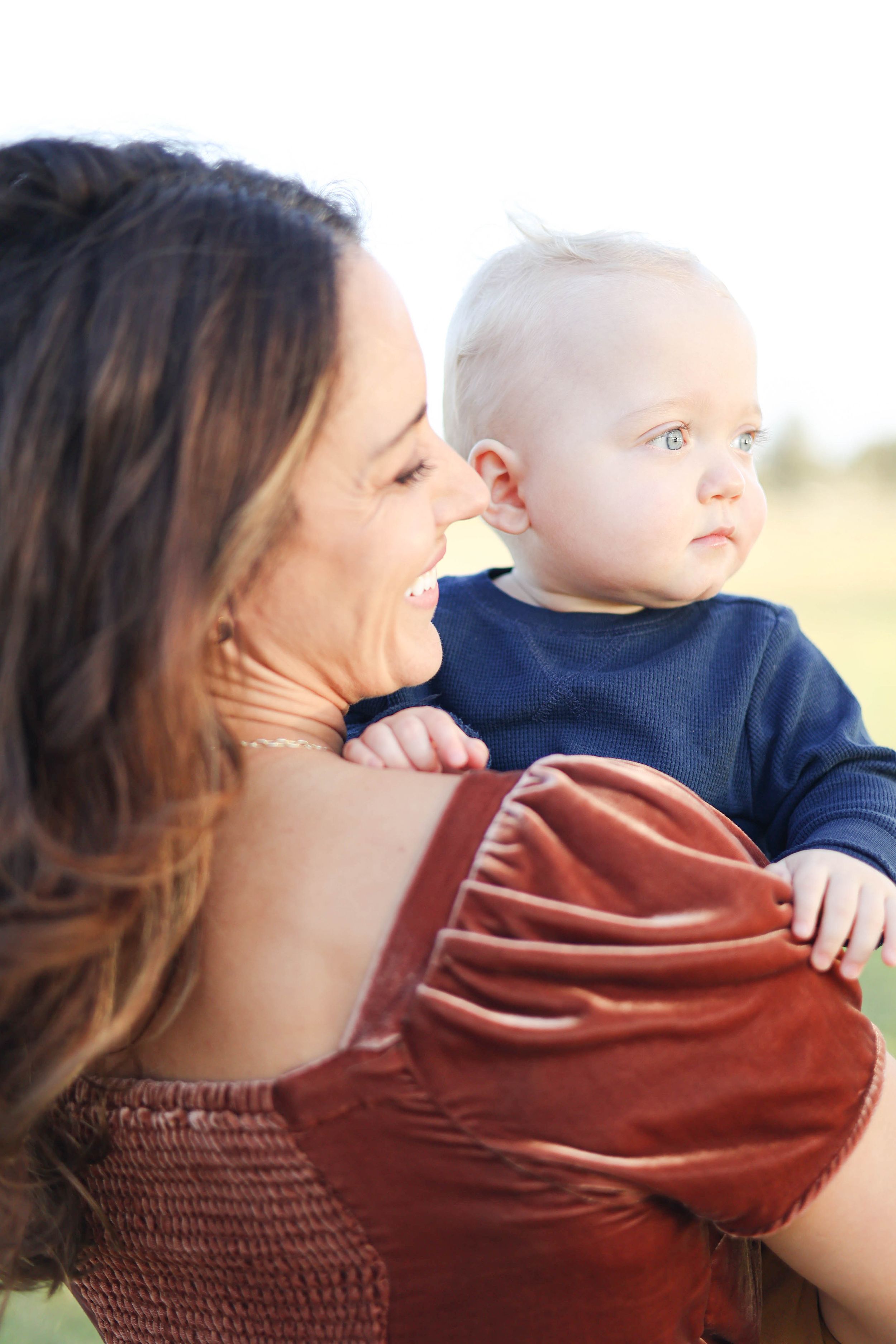 Mom and baby looking at sunset.
