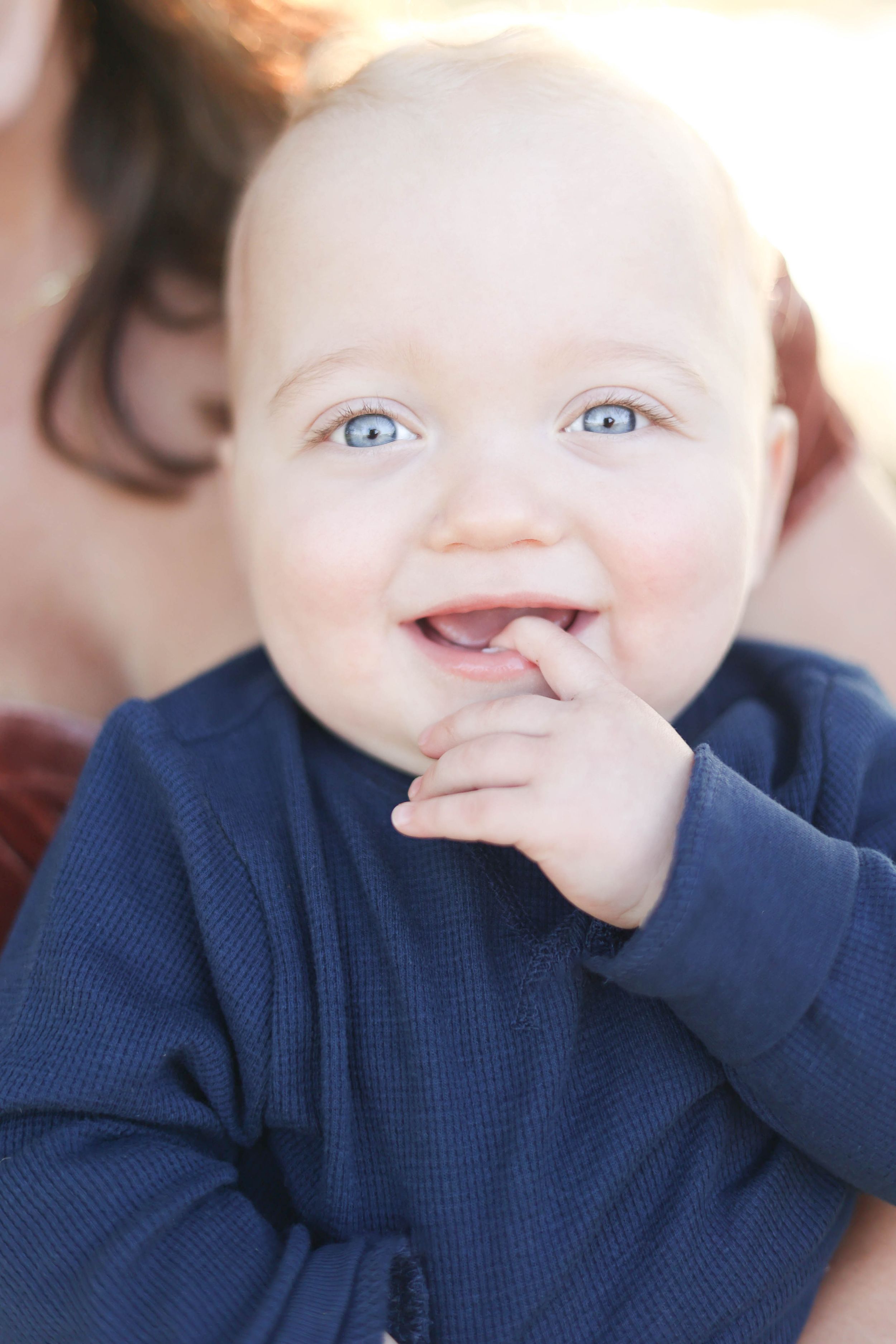 Baby smiling and laughing, big blue eyes.